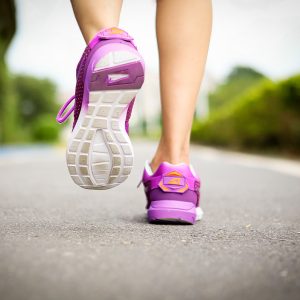 athlete runner feet running on road closeup on shoe woman fitness jog workout wellness concept t20 VKnO4l